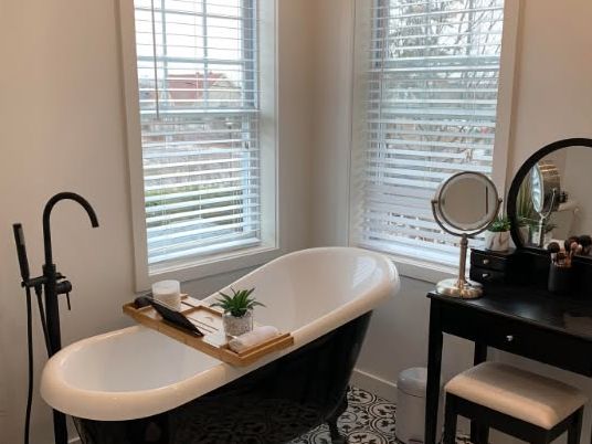 Salle de bain refaite avec baignoire sur pattes et plancher de céramique à motifs